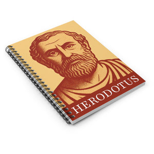 Spiral notebook with a bold orange and yellow illustration of Greek historian Herodotus lying flat on a white surface