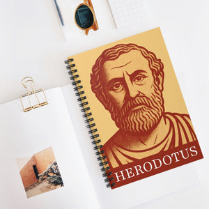 Spiral notebook with a bold orange and yellow illustration of Greek historian Herodotus on a white surface