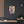 Canvas wall art with a bold purple and beige Illustration of Greek statesman Pericles on a dark wall above a shelf