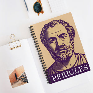 Spiral notebook with a purple and beige portrait of Pericles lying flat on a white surface in context with other items