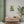 Fine art poster with a bold green and beige illustration of ancient Greek philosopher Socrates in interior room