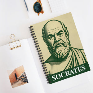 Spiral notebook with a bold green and beige illustration of ancient Greek philosopher Socrates on a flat white surface overhead view