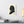 Canvas wall art with a black on ivory silhouette illustration of musician Johann Sebastian Bach on a wall above a desk with books and a lamp.