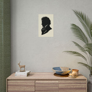Fine art poster with a black on ivory silhouette illustration of musician Ludwig van Beethoven on a wall above a wooden console table with decorative items.