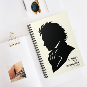 Spiral notebook with a black on ivory silhouette illustration of musician Ludwig van Beethoven on a white surface