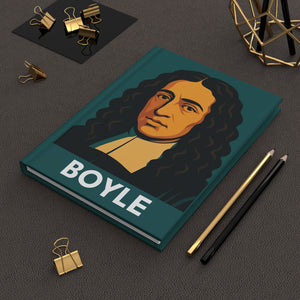 Hardcover journal with a bold illustration of chemist and scientist Roberty Boyle on a dark surface with office supplies.