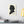 Canvas wall art with a black on ivory silhouette illustration of musician Frederic Chopin above a desk with books and a lamp.