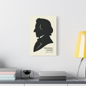Canvas wall art with a black on ivory silhouette illustration of musician Frederic Chopin above a desk with books and a lamp.