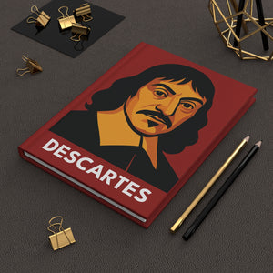 Hardcover journal with a bold illustration of mathematician and philosopher Rene Descartes on a dark surface with office supplies