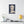 Canvas wall art with a bold illustration of Roman emperor Domitian on a wall above a desk with decor items.