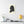Canvas wall art with a black on ivory silhouette illustration of musician George Frideric Handel with a yellow lamp and books on a shelf.