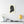Canvas wall art with a black on ivory silhouette illustration of musician Joseph Haydn on a wall above a shelf with decor items.