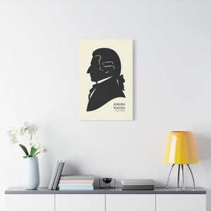 Canvas wall art with a black on ivory silhouette illustration of musician Joseph Haydn on a wall above a shelf with decor items.