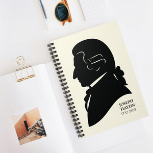 Spiral notebook with a black on ivory silhouette illustration of musician Joseph Haydn on a white surface