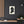 Canvas wall art with a black on ivory silhouette illustration of musician Franz Liszt on a dark wall with wooden shelves and decor.