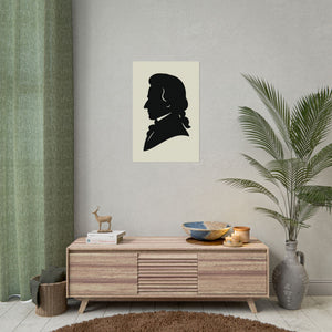 Fine art poster with a black on ivory silhouette illustration of musician Wolfgang Amadeus Mozart wall above a wooden cabinet with decorative items.