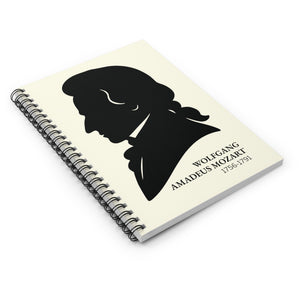 Spiral notebook with a black on ivory silhouette illustration of musician Wolfgang Amadeus Mozart lying flat on a white surface