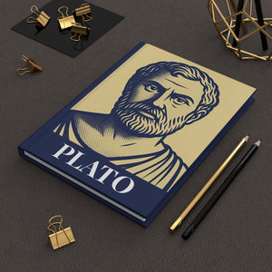 Hardcover journal with a bold illustration of ancient Greek philosopher Plato
on a dark surface with office supplies.