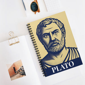 Spiral notebook with a bold illustration of ancient Greek philosopher Plato on a white surface with sunglasses and a photo clip.