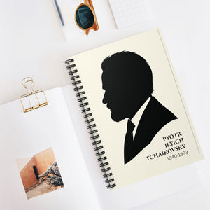 Spiral notebook with a black on ivory silhouette illustration of musician Pyotr Ilyich Tchaikovsky on a white surface mockup