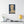 Canvas wall art with a bold illustration of Roman emperor Tiberius on a wall above a shelf with decor items.