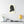 Canvas wall art with a black on ivory silhouette illustration of musician Antonio Vivaldi on a wall above a shelf with decor items.